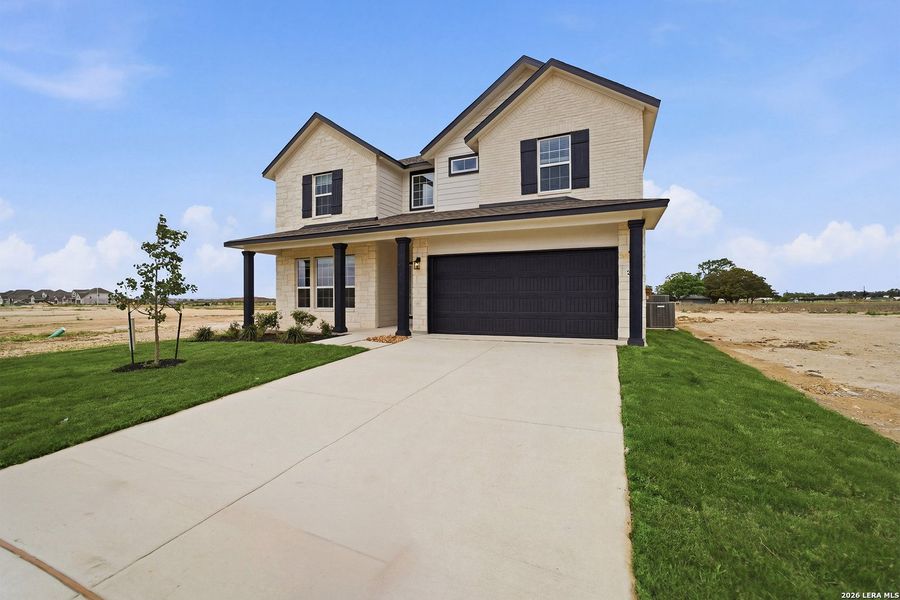 Front exterior of a new home in Megan's Landing, Castroville, TX, highlighting curb appeal (Image 21).