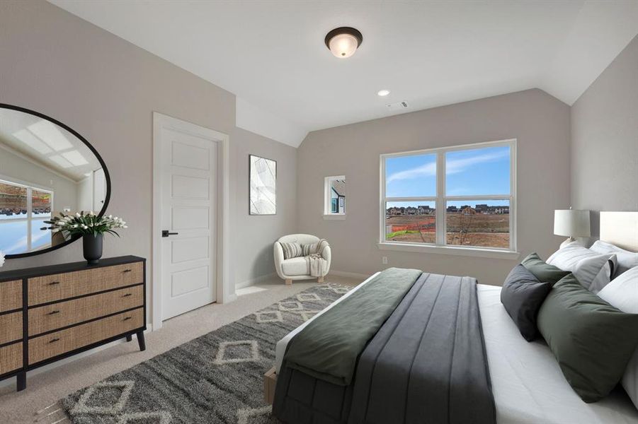 Bedroom with lofted ceiling and light carpet