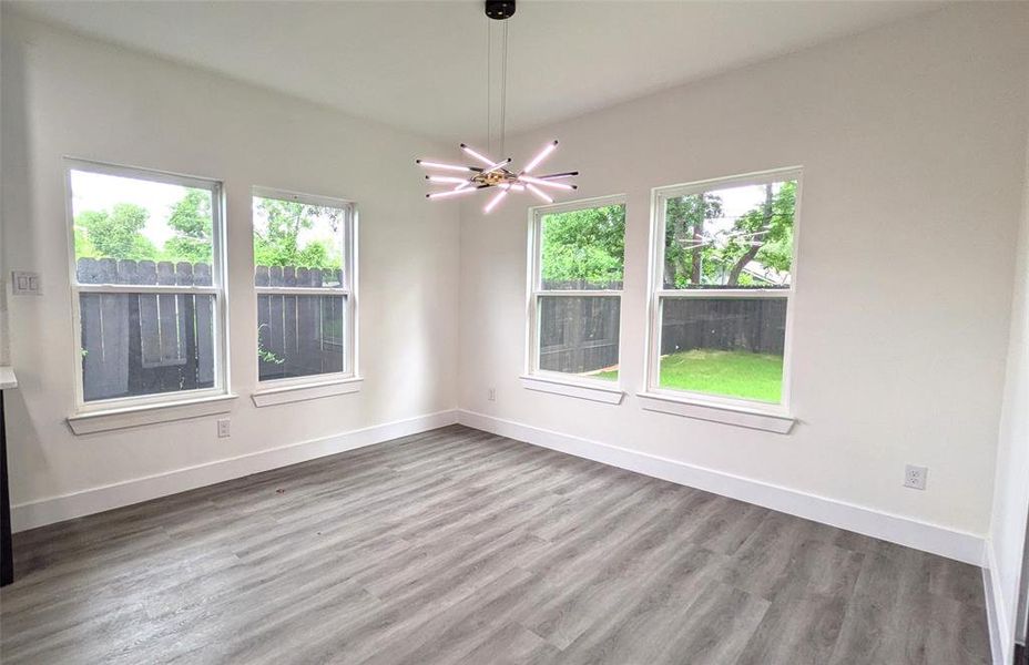 Empty room featuring baseboards and wood finished floors
