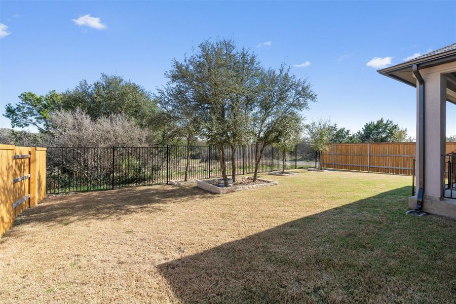 Fenced backyard with a patio
