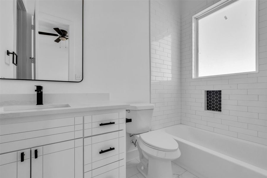 A closer look of this well-appointedbathroom, featuring a tub andshower combo, a vanity mirror, asingle sink, and a convenientcloset for added storage. A closer look of this well-appointedbathroom, featuring a tub andshower combo, a vanity mirror, asingle sink, and a convenientcloset for added storage.