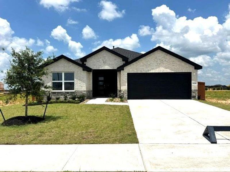 Front exterior of a new home in Sunterra Lakes, Brookshire, TX, highlighting curb appeal (Image 1). Front exterior of a new home in Sunterra Lakes, Brookshire, TX, highlighting curb appeal (Image 1).