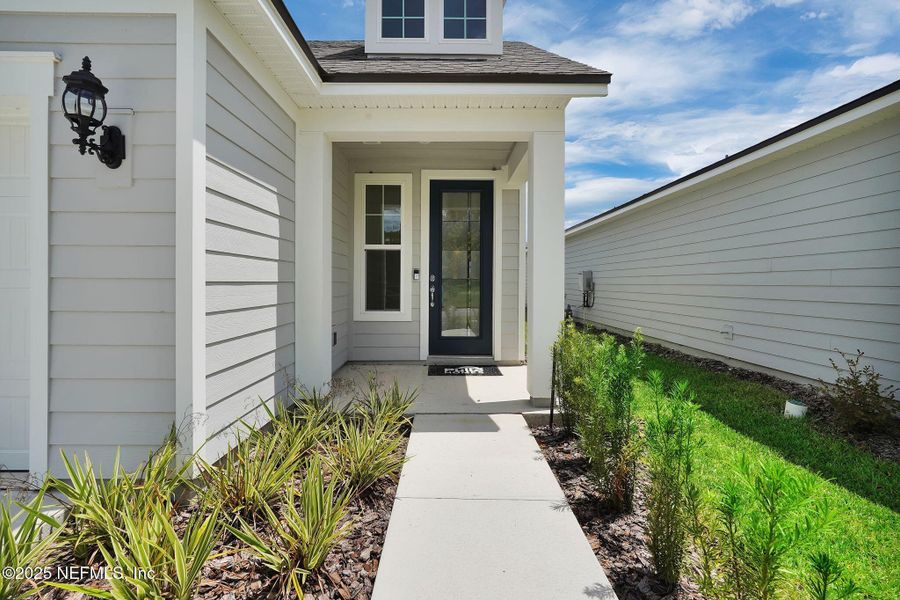 Front exterior of a new home in Summer Bay at Grand Oaks, St. Augustine, FL, highlighting curb appeal (Image 15).