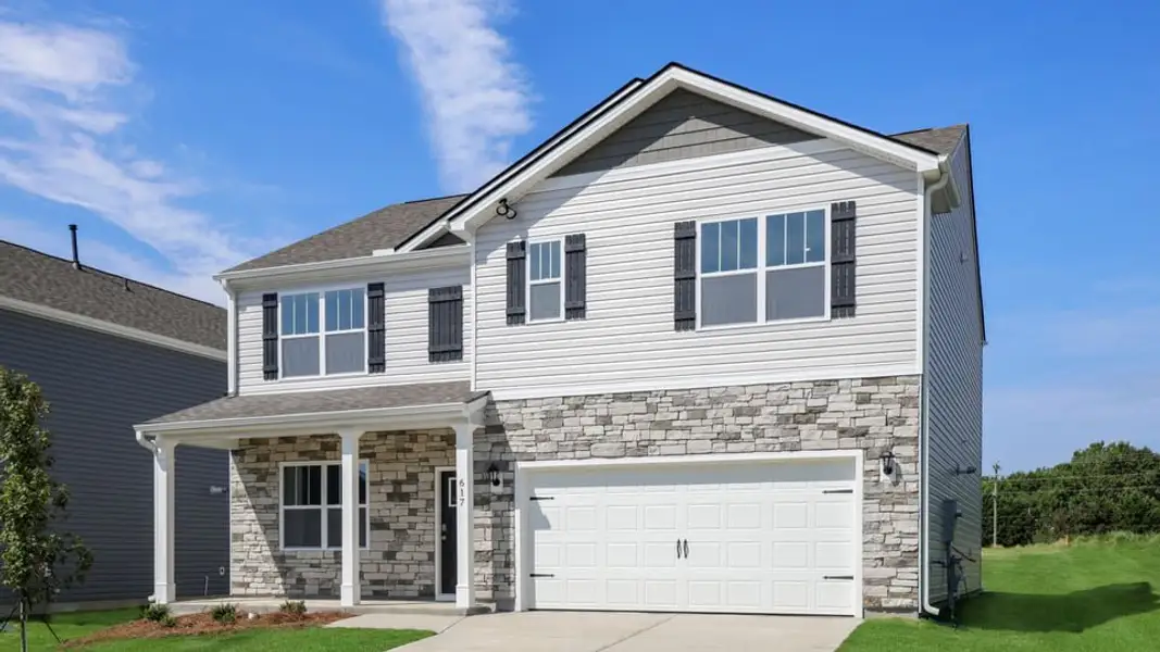 Front exterior of a new home in Durbin Meadows Traditions, Fountain Inn, SC, highlighting curb appeal (Image 2). Front exterior of a new home in Durbin Meadows Traditions, Fountain Inn, SC, highlighting curb appeal (Image 2).