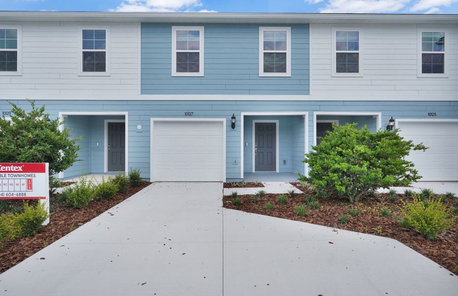 Front exterior of a new home in Normandy Pines, Jacksonville, FL, highlighting curb appeal (Image 1). Front exterior of a new home in Normandy Pines, Jacksonville, FL, highlighting curb appeal (Image 1).
