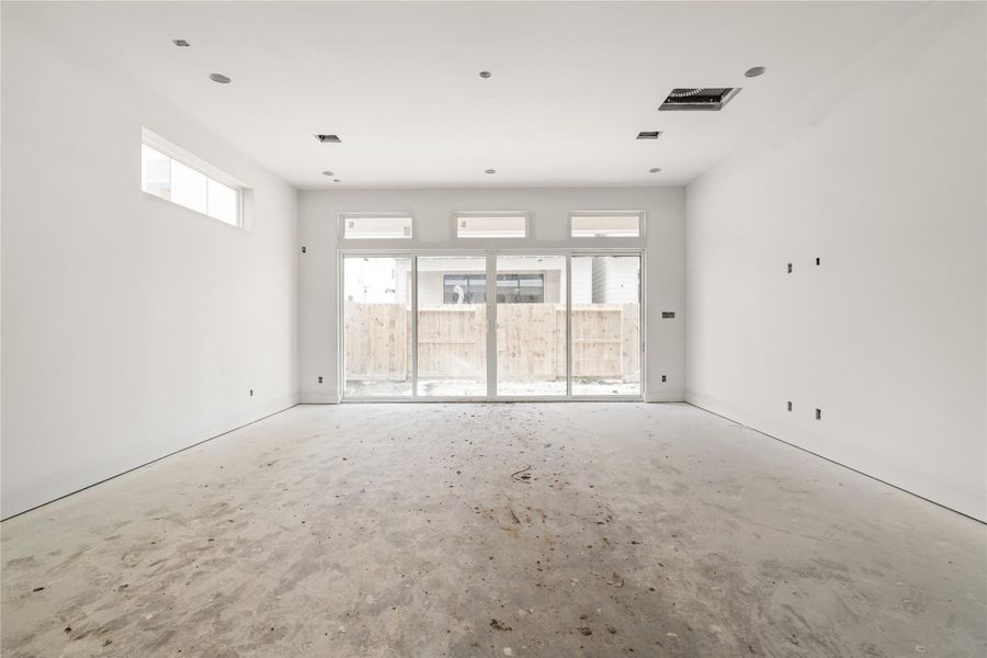 Living room with oversized sliding glass door opens to your covered patio and backyard, while letting in lots of natural light.