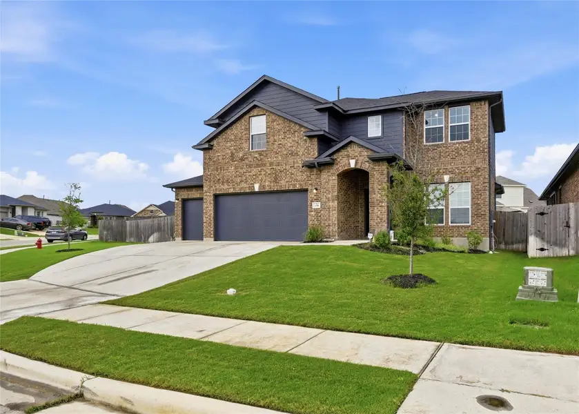 Front exterior of a new home in Sunfield, Buda, TX, highlighting curb appeal (Image 2).