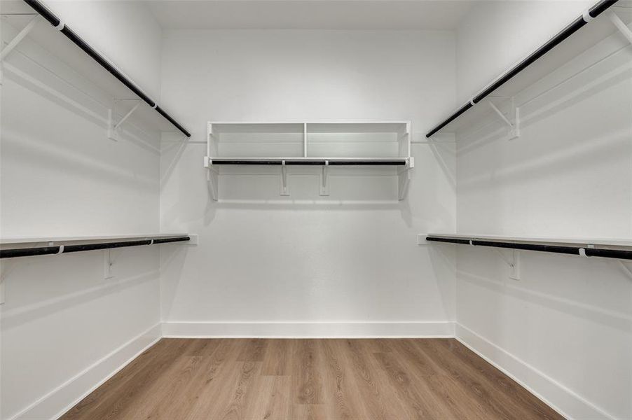 Spacious closet with light wood-style floors