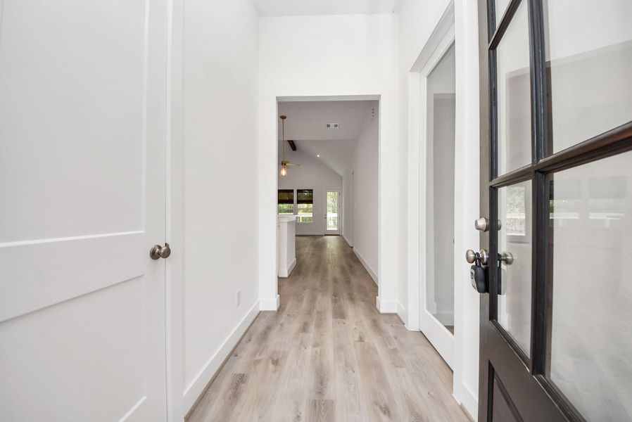 Bright hallway featuring tall ceilings and plenty of natural light.