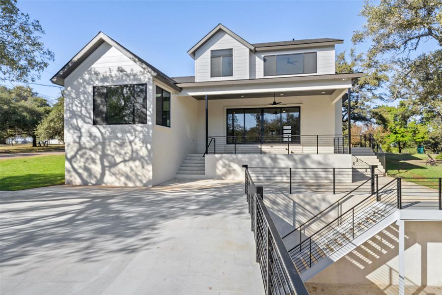 View of front of property with stairway, stucco siding, and a ceiling fan View of front of property with stairway, stucco siding, and a ceiling fan