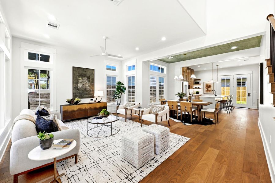An inviting open-concept living space features warm hardwood floors and abundant natural light. An inviting open-concept living space features warm hardwood floors and abundant natural light.