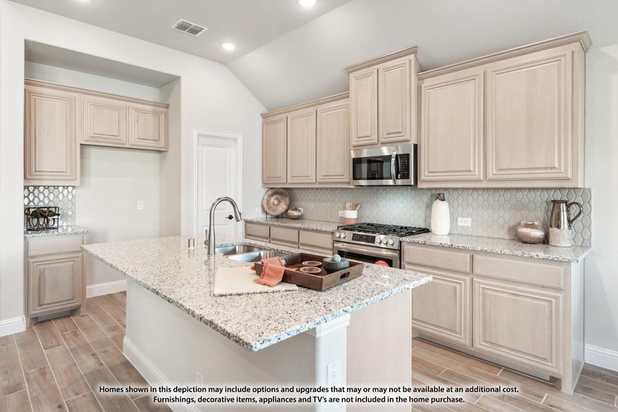 Kitchen with cream cabinets, granite island, tile backsplash, and stainless steel appliances on wood-look floors