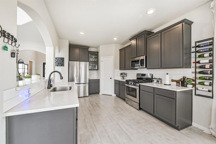 Tile floors make for easy kitchen clean up; while the stainless steal appliance package, quartz countertops, and display cabinetry showcase effortless style. Tile floors make for easy kitchen clean up; while the stainless steal appliance package, quartz countertops, and display cabinetry showcase effortless style.