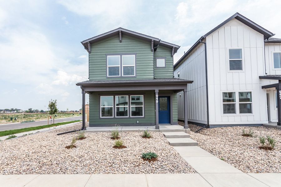 Front exterior of a new home in Prairie Song, Windsor, CO, highlighting curb appeal (Image 1). Front exterior of a new home in Prairie Song, Windsor, CO, highlighting curb appeal (Image 1).