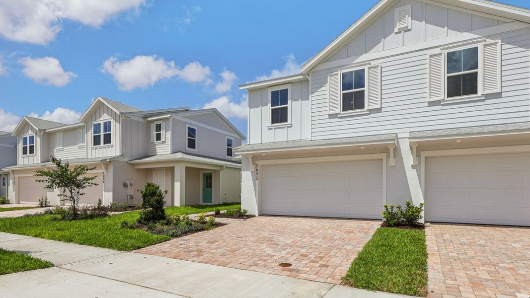 Front exterior of a new home in Cyrene at Harmony, St. Cloud, FL, highlighting curb appeal (Image 1). Front exterior of a new home in Cyrene at Harmony, St. Cloud, FL, highlighting curb appeal (Image 1).