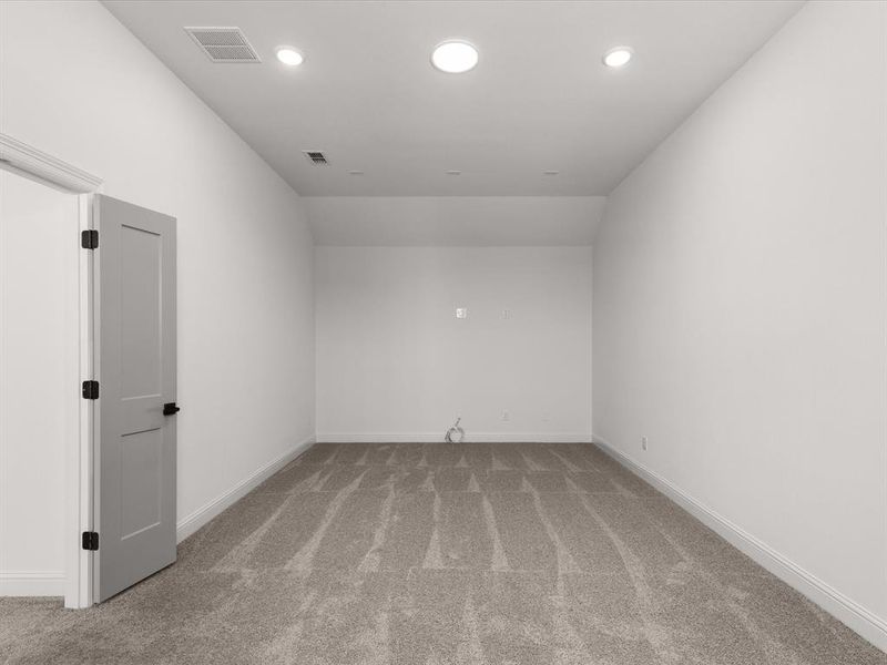 Spare room featuring light colored carpet and recessed lighting