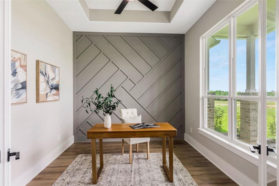 Home office with large windows providing plenty of natural light, and features a stylish accent wall Home office with large windows providing plenty of natural light, and features a stylish accent wall