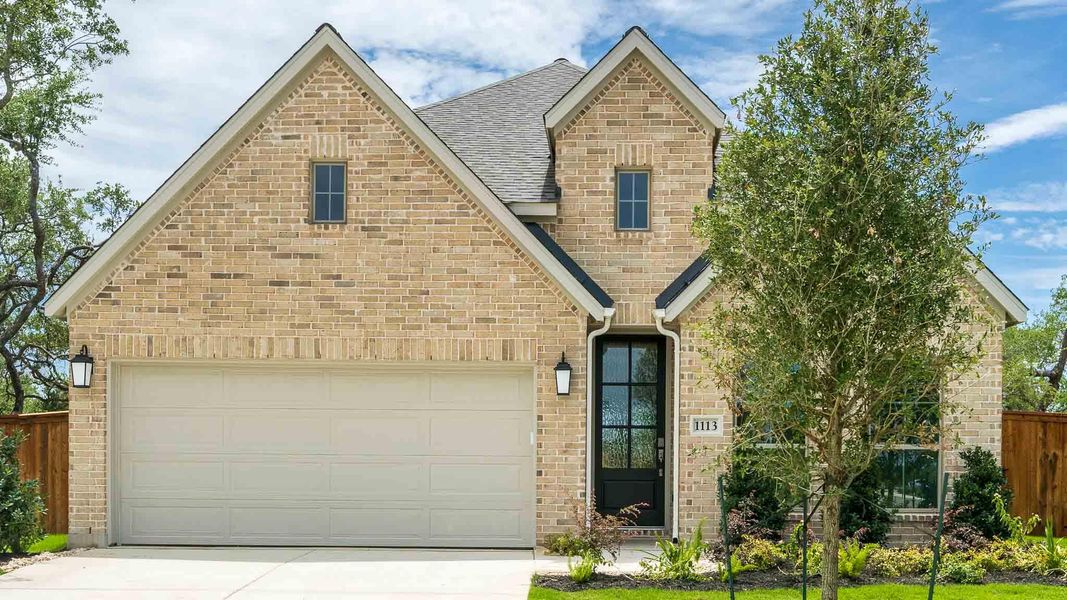 View of front of home featuring a shingled roof, driveway, brick siding, and a garage View of front of home featuring a shingled roof, driveway, brick siding, and a garage