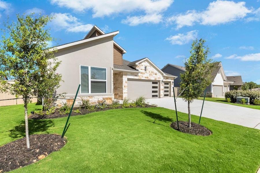 Front exterior of a new home in The Colony, Bastrop, TX, highlighting curb appeal (Image 1).