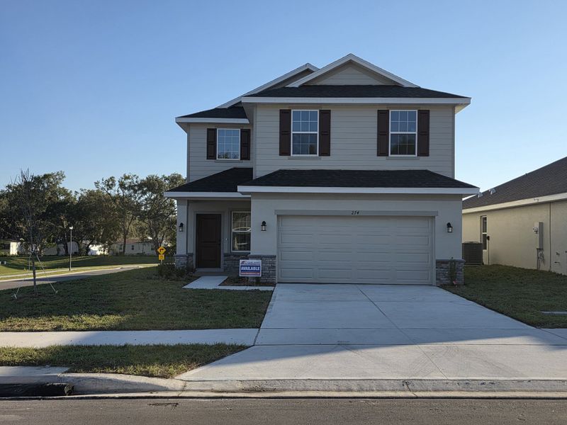 Front exterior of a new home in Arbor Park, Leesburg, FL, highlighting curb appeal (Image 1).