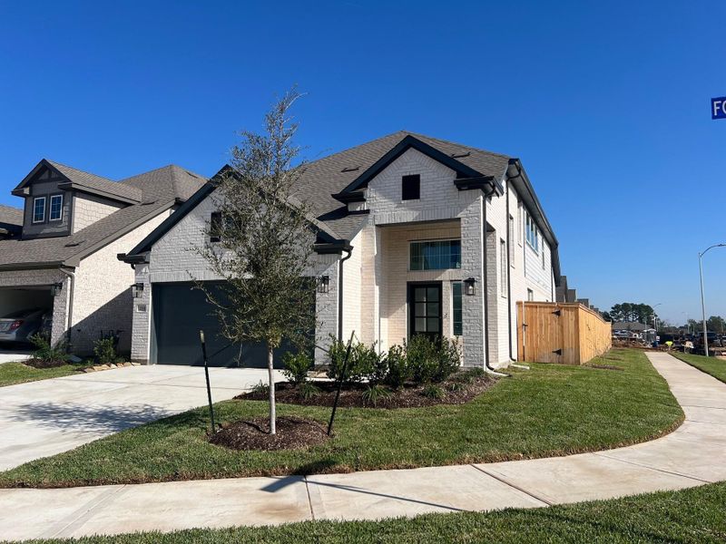 Front exterior of a new home in Wood Leaf Reserve, Tomball, TX, highlighting curb appeal (Image 13). Front exterior of a new home in Wood Leaf Reserve, Tomball, TX, highlighting curb appeal (Image 13).