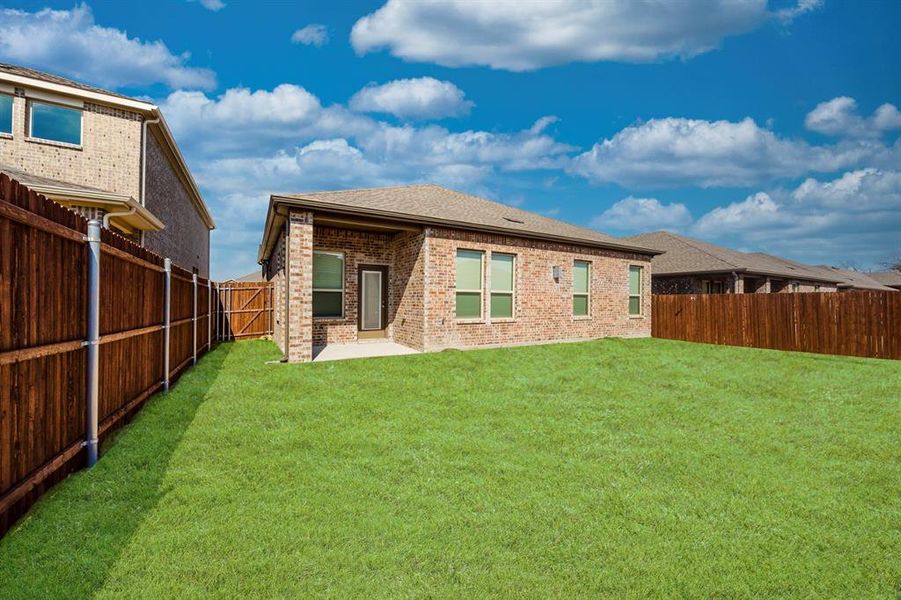 Rear view of property with a yard and a patio area