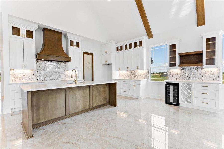 Bright, open-concept kitchen featuring a large island, custom cabinetry, and beautiful finishes. Bright, open-concept kitchen featuring a large island, custom cabinetry, and beautiful finishes.