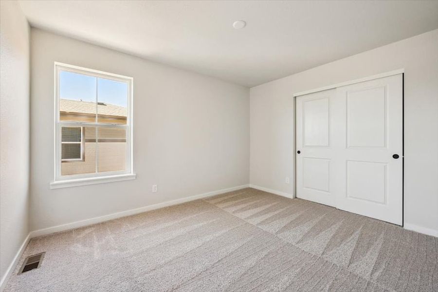A room with white doors and a window.