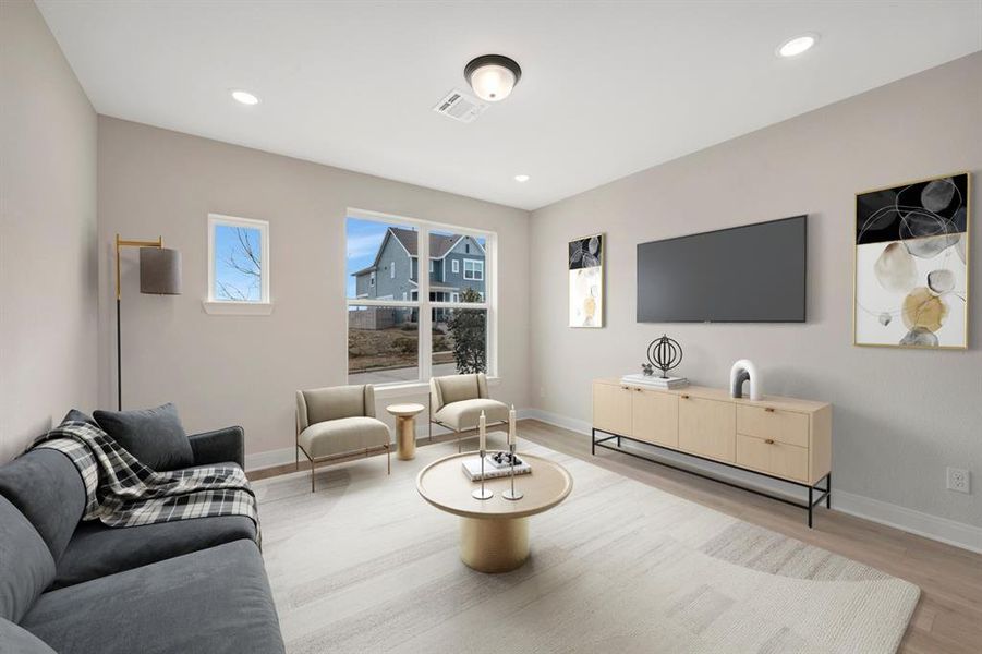 Living room featuring wood finished floors and recessed lighting