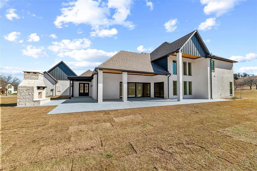 Large ourdoor pavered patio with custom stone fireplace