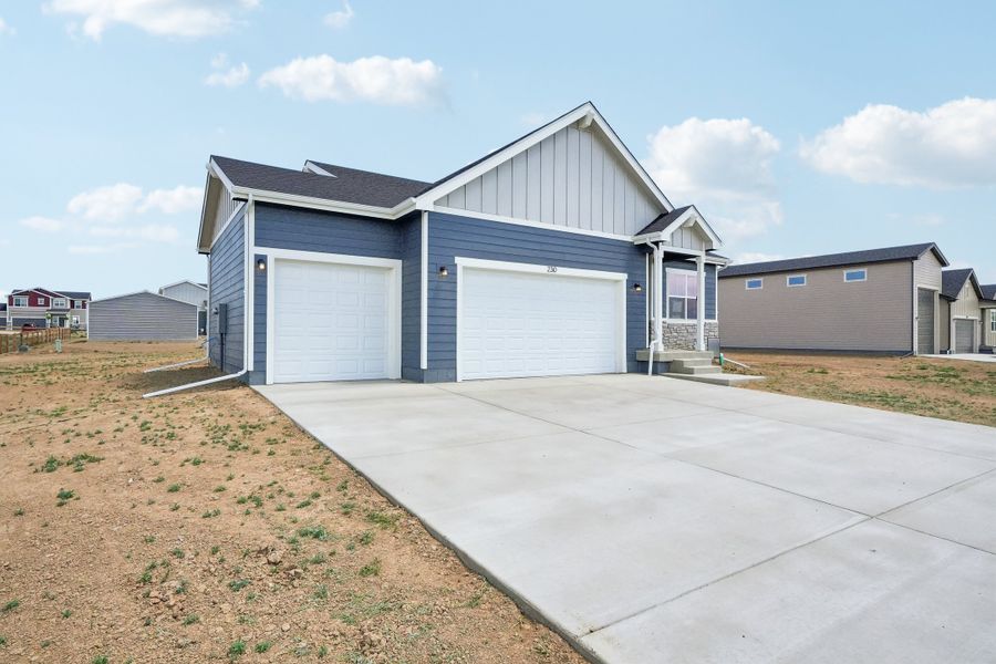 Front exterior of a new home in Hudson Hills, Hudson, CO, highlighting curb appeal (Image 24). Front exterior of a new home in Hudson Hills, Hudson, CO, highlighting curb appeal (Image 24).