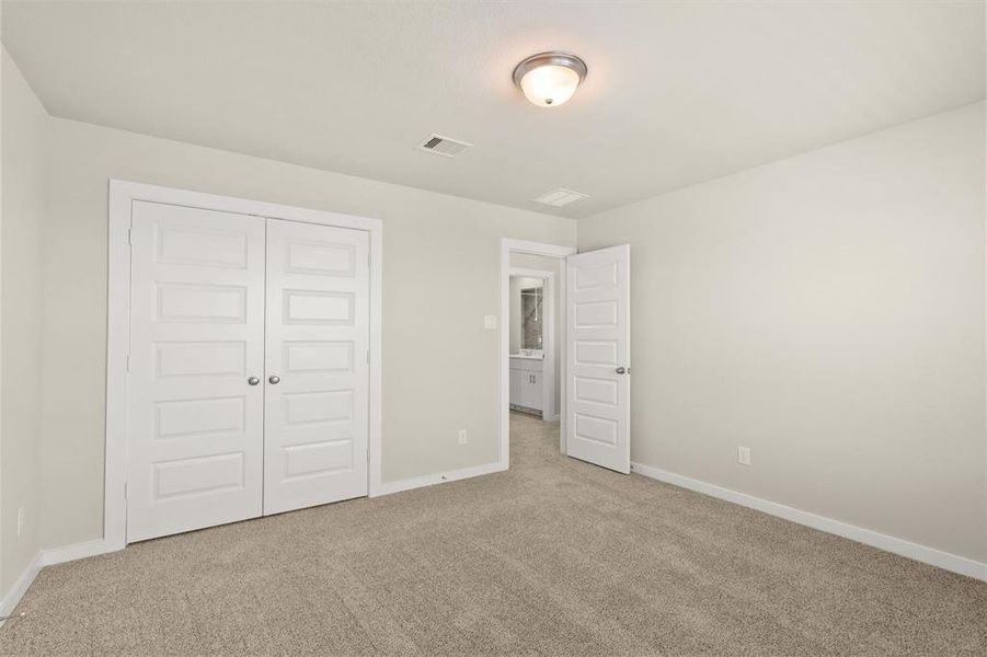 Striking Secondary bedroom on second floor featuring plush carpet, neutral finishes and easy access to the Flex Space and bathroom.