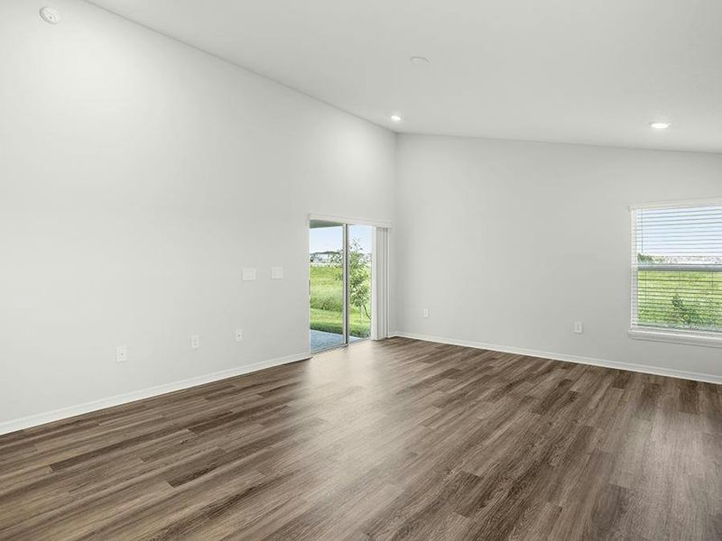 Enjoy a sunny, open living area with airy volume ceilings and low-maintenance LVP flooring.