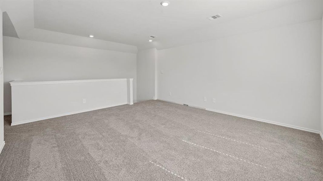 Empty room featuring light carpet and recessed lighting