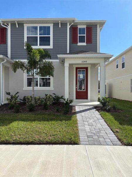Front exterior of a new home in Gardenia Reserve, Apopka, FL, highlighting curb appeal (Image 1). Front exterior of a new home in Gardenia Reserve, Apopka, FL, highlighting curb appeal (Image 1).