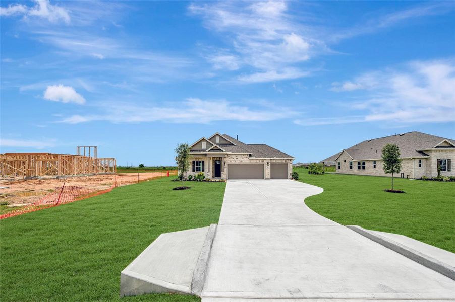 Front exterior of a new home in Cane Crossing Estates, Sealy, TX, highlighting curb appeal (Image 27).