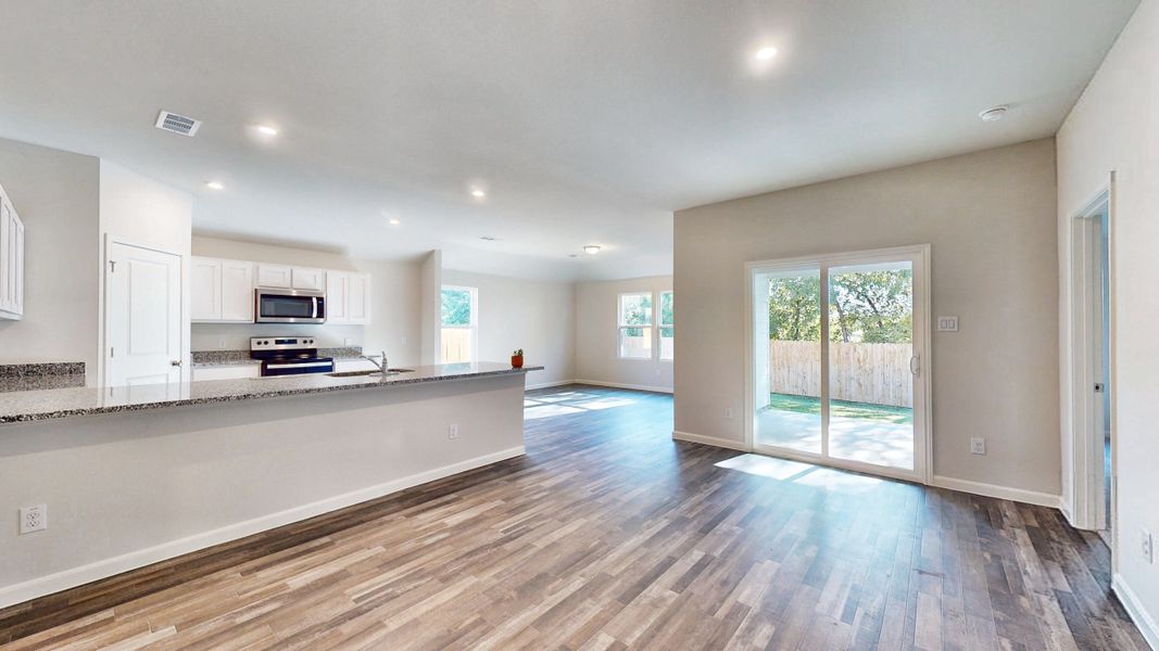 A large kitchen with a large wooden floor. A large kitchen with a large wooden floor.