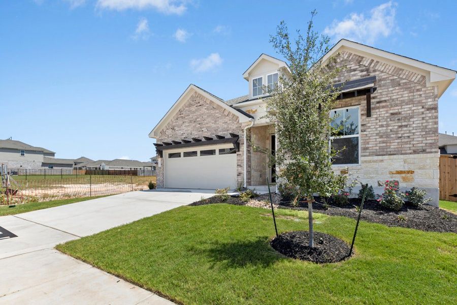 Front exterior of a new home in University Heights, Round Rock, TX, highlighting curb appeal (Image 19).
