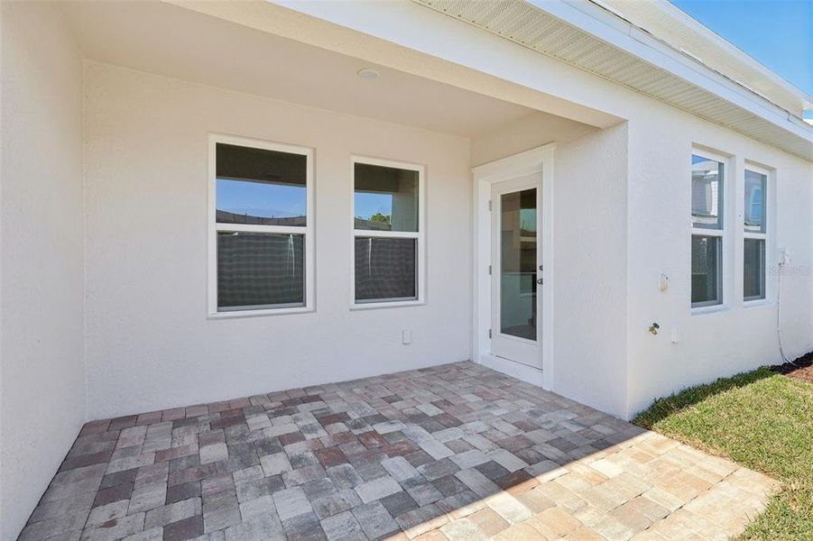 Exterior details and patio area of a home in Cyrene at Harmony, St. Cloud (Image 22).