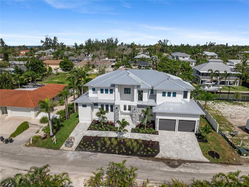 Front exterior of a new home in , Longboat Key, FL, highlighting curb appeal (Image 26). Front exterior of a new home in , Longboat Key, FL, highlighting curb appeal (Image 26).