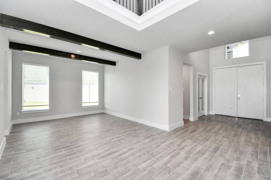 Craft enduring memories with loved ones around the table! This roomy dining area boasts stylish flooring, personalized paint, and is conveniently situated next to the family room and kitchen, fostering an open and inclusive ambiance. Sample photo of completed home with similar floor plan. Actual colors and selections may vary.