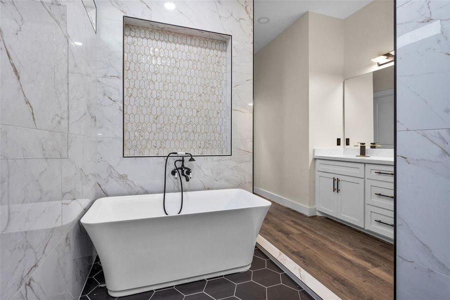 And here is your fabulous soaker tub. Notice all of the all the tile work bringing so much class in and don't you just love the thought of that luxurious deep tub?