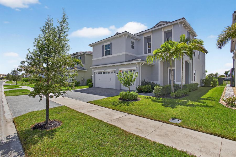 Front exterior of a new home in , The Acreage, FL, highlighting curb appeal (Image 24).