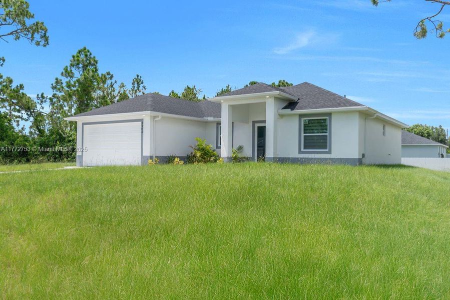 Front exterior of a new home in , Lehigh Acres, FL, highlighting curb appeal (Image 17).