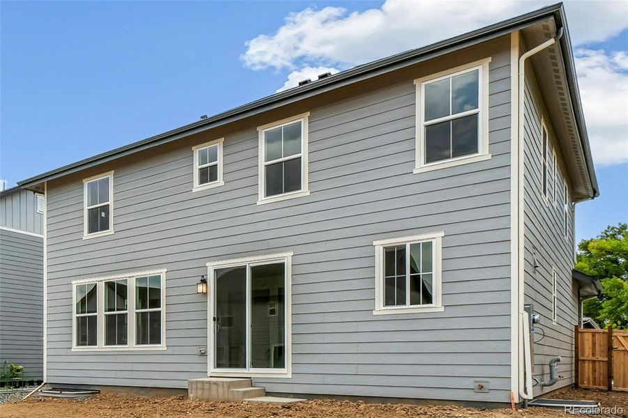 Front exterior of a new home in Windsong, Thornton, CO, highlighting curb appeal (Image 20).