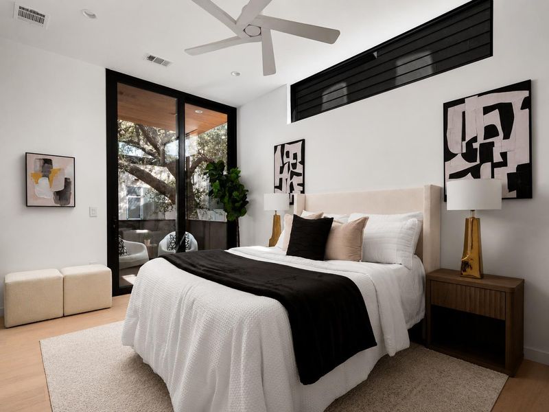 Floor-to-ceiling glass sliding doors integrate indoor comfort with outdoor balcony access.
