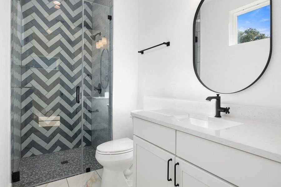 Full bathroom with vanity and a shower stall