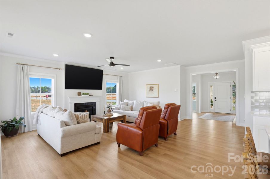 A cozy fireplace and an open layout that flows effortlessly back to the welcoming foyer, perfect for both relaxing and entertaining.