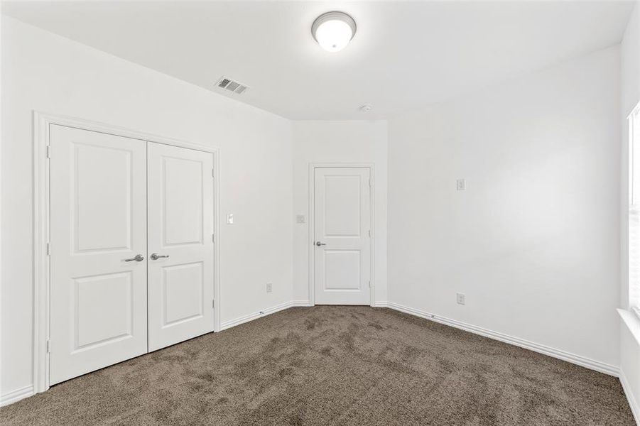 Unfurnished bedroom featuring a closet and carpet flooring