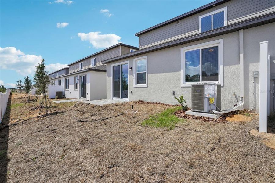 Front exterior of a new home in Cyrene at Minneola - Villas, Montverde, FL, highlighting curb appeal (Image 22). Front exterior of a new home in Cyrene at Minneola - Villas, Montverde, FL, highlighting curb appeal (Image 22).